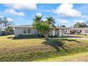 House exterior showcasing a landscaped lawn and palm trees at 106 Aurora E St, Venice, FL 34285