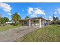 Inviting home with covered parking, palm trees, and a well-kept lawn at 106 Aurora E St, Venice, FL 34285