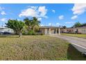 Well-maintained single-story home featuring a covered carport and mature landscaping at 106 Aurora E St, Venice, FL 34285