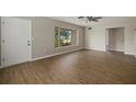Bright living room featuring wood-look floors and large windows at 106 Aurora E St, Venice, FL 34285