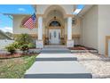 Front entryway with stairs leading to the porch at 15806 Adobe Dr, Hudson, FL 34667