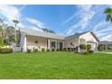 Charming house with a well-maintained lawn and palm trees at 2647 Royal Ridge Dr, Spring Hill, FL 34606