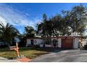 House with a well-maintained lawn and driveway, plus a basketball hoop at 3322 Fairmount Dr, Holiday, FL 34691