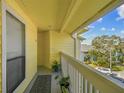 Private balcony with white railings and potted plants at 455 Alt 19 S # 163, Palm Harbor, FL 34683
