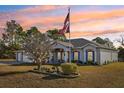 House exterior with American flag, festive lights, and manicured lawn at 5452 Queen Ave, Spring Hill, FL 34609