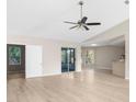 Spacious living room, featuring light floors and access to a screened porch at 1393 Leeward Ave, Spring Hill, FL 34606