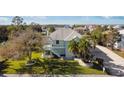 Two-story waterfront home with driveway and manicured lawn at 3207 Hibiscus Dr, Hernando Beach, FL 34607