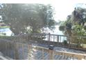 Wooden deck overlooking a serene canal with lush greenery at 3518 Moog Rd, Holiday, FL 34691