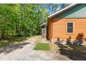 Log cabin home exterior with lush green lawn and landscaped walkway at 6051 Valley Spring Dr, Brooksville, FL 34601