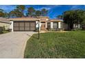Inviting home with a well-kept lawn and a front-facing two-car garage for convenience at 9519 Green Needle Dr, New Port Richey, FL 34655