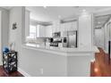 Bright kitchen featuring white cabinets, stainless steel appliances, and a breakfast bar at 3312 Francoa Dr, Odessa, FL 33556