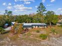 Expansive aerial view of the home's exterior, including the landscaping and surrounding trees at 7815 Tanglewood Dr, New Port Richey, FL 34654