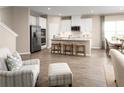 Modern open concept kitchen and dining area with stainless steel appliances and hardwood floors at 10008 Zennia Ln, Parrish, FL 34219