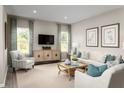 Bright living room with stylish decor, large windows, comfortable seating, and mounted television at 10008 Zennia Ln, Parrish, FL 34219