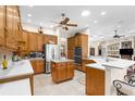 Well-lit kitchen featuring wooden cabinets, stainless steel appliances, and a center island at 10124 Southern Breeze Ct, Weeki Wachee, FL 34613