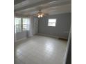 Bright living room with tile flooring, beamed ceilings and a ceiling fan at 4011 W Mango Ave, Tampa, FL 33616