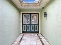 Inviting front double door features decorative glass, black hardware and sidelights at 12529 Shadow Ridge Blvd, Hudson, FL 34669