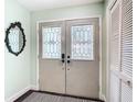 Interior view of the decorative double door with glass inserts and a closet at 12529 Shadow Ridge Blvd, Hudson, FL 34669