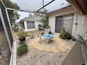 Enclosed patio with decorative fountain, gravel, and stepping stones at 8111 Merrimac Dr, Port Richey, FL 34668