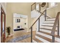 Bright foyer featuring wood floors, open staircase, and view to office space at 9617 Norchester Cir, Tampa, FL 33647