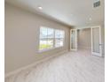 Bright bedroom with large windows and access to additional space through double doors at 10126 Zennia Ln, Parrish, FL 34219