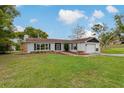 Charming single-story home with a well-manicured lawn, stone accents and an inviting driveway at 10200 Sunburst Ct, Spring Hill, FL 34608