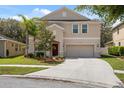 Two-story home with a two-car garage and landscaping at 12307 Duckett Ct, Spring Hill, FL 34610