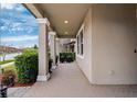Welcoming front porch featuring classic columns and neutral tones at 9173 Shadyside Ln, Land O Lakes, FL 34637