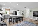 Stylish kitchen with a large center island, white and gray cabinetry, and tile flooring at 14124 Kulig Ct, Hudson, FL 34667
