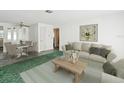 Inviting living room with neutral tones, a stylish couch, and a decorative floral painting above it at 7037 Versailles N # 15, Pinellas Park, FL 33781