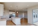 Modern kitchen with stainless steel appliances, island, and a seamless connection to the living area at 10118 Zennia Ln, Parrish, FL 34219