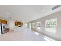 Bright, open-concept living room with natural light and sliding glass doors to outdoor at 10123 Zennia Ln, Parrish, FL 34219