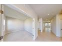 Bright hallway with neutral paint, tile flooring, and access to multiple rooms within the home at 10127 Zennia Ln, Parrish, FL 34219