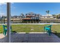 Waterfront backyard with dock, boat lift, and seating area, perfect for enjoying the water view at 13705 Allyn Dr, Hudson, FL 34667