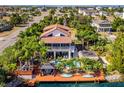 Beautiful waterfront home with a private dock, pool, and tropical landscaping at 3308 Oleander Dr, Hernando Beach, FL 34607