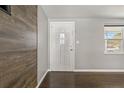 Charming entryway with a white door, hardwood floors, and neutral wall paint at 3540 Linkwood St, New Port Richey, FL 34652