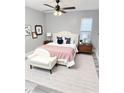 Inviting bedroom featuring a plush bed, decorative pillows, a ceiling fan, and a cozy bench at 4218 San Rafael Ave, New Port Richey, FL 34655