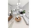 Bright living room features modern furnishings, neutral tones, and an open layout, perfect for entertaining and relaxing at 4218 San Rafael Ave, New Port Richey, FL 34655