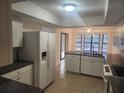 A well-lit kitchen with white cabinets, modern appliances, and plenty of counter space at 9179 Gillmar St, Spring Hill, FL 34608