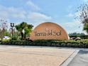 Welcoming Tierra del Sol community sign with professional landscaping and blue skies in the background at 18819 Sunterra Dr, Land O Lakes, FL 34638