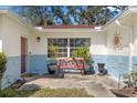 Inviting front entrance featuring a cozy bench and decorative plants enhancing the curb appeal at 337 Hartwood Ave, Spring Hill, FL 34606