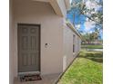 A charming front entrance with a Welcome mat, Ring doorbell, and view of the lake at 5548 Cannonade Dr, Wesley Chapel, FL 33544