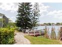 Scenic waterfront backyard with a charming walkway and private dock for enjoying lakeside living at 5771 Catskill Rd, Holiday, FL 34690
