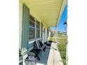 Inviting covered porch with seating, offering a cozy spot to relax at 3523 Cambridge St, New Port Richey, FL 34652