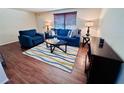 Spacious living room featuring comfortable seating, a striped rug, and bright natural light at 3523 Cambridge St, New Port Richey, FL 34652