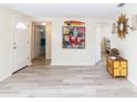 Inviting foyer with tile floors, decorative art, and open doorways leading to other rooms at 3526 Overland Dr, Holiday, FL 34691