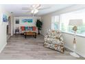 Bright living room featuring wood floors, comfortable seating, a ceiling fan and lots of natural light at 3526 Overland Dr, Holiday, FL 34691