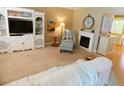 Inviting living room features a fireplace and built-in shelving at 4801 Airport Rd # 208, Zephyrhills, FL 33542