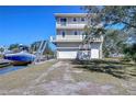 Attractive waterfront home with three stories, balconies, and private boat dock at 6801 Nowiki Ave, Hudson, FL 34667