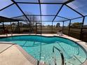 Sparkling screened-in pool, perfect for swimming and entertaining at 13026 Lawrence St, Spring Hill, FL 34609